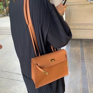 The Row black cardigan *seen on Chrissy Teigen*